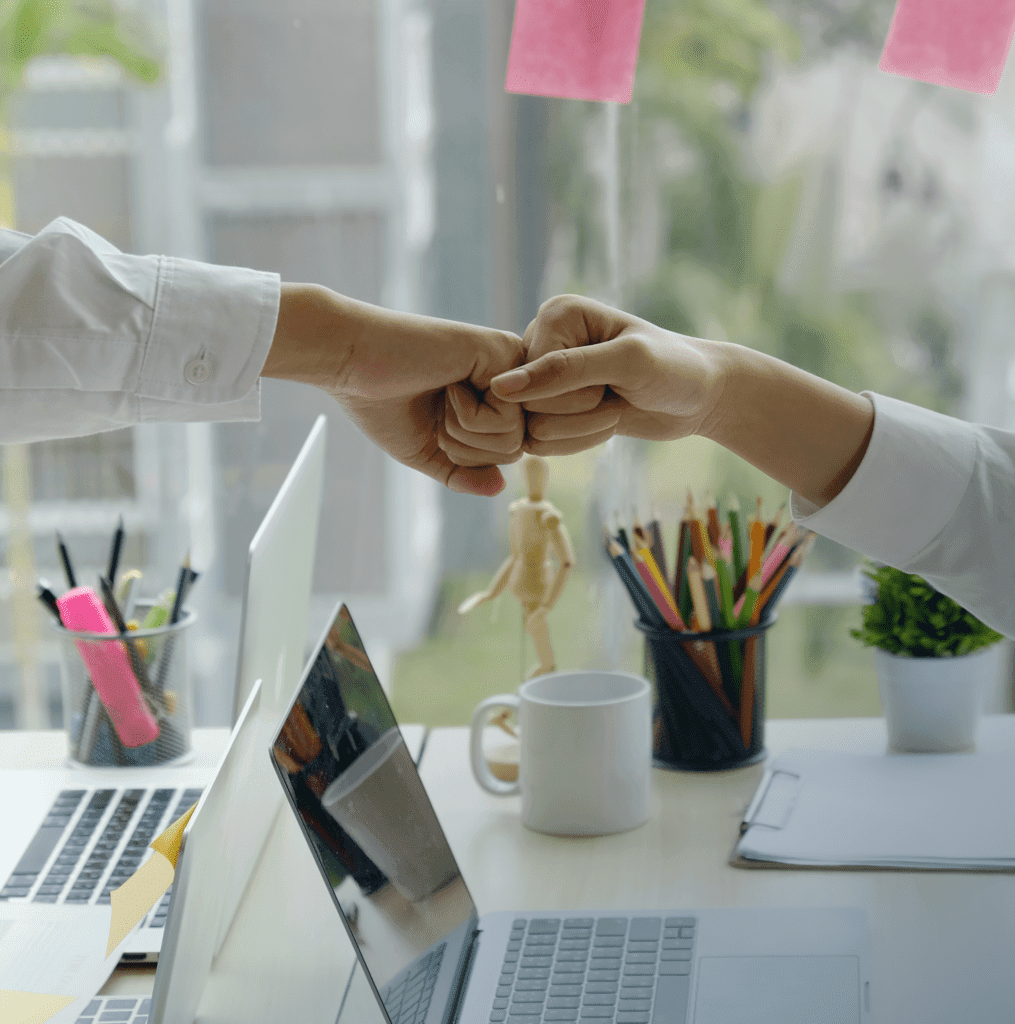 Businessman and businesswoman celebrating success in office