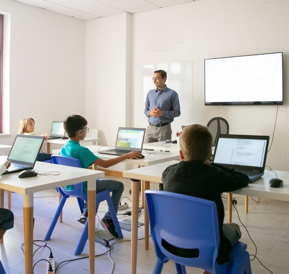 confident teacher explaining lesson pupils